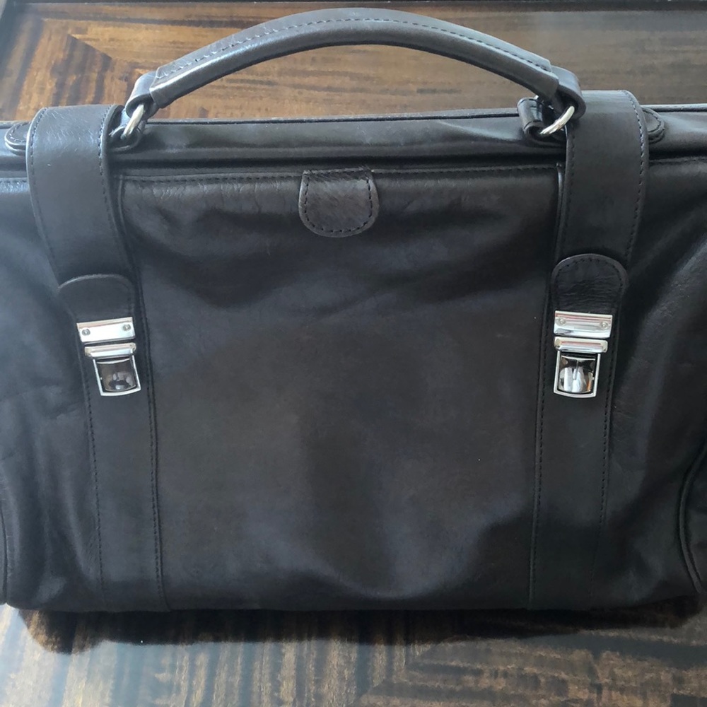 Coty brown leather travel bag.